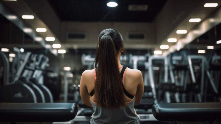 pngtree woman stands in gym with her back view image 2509511